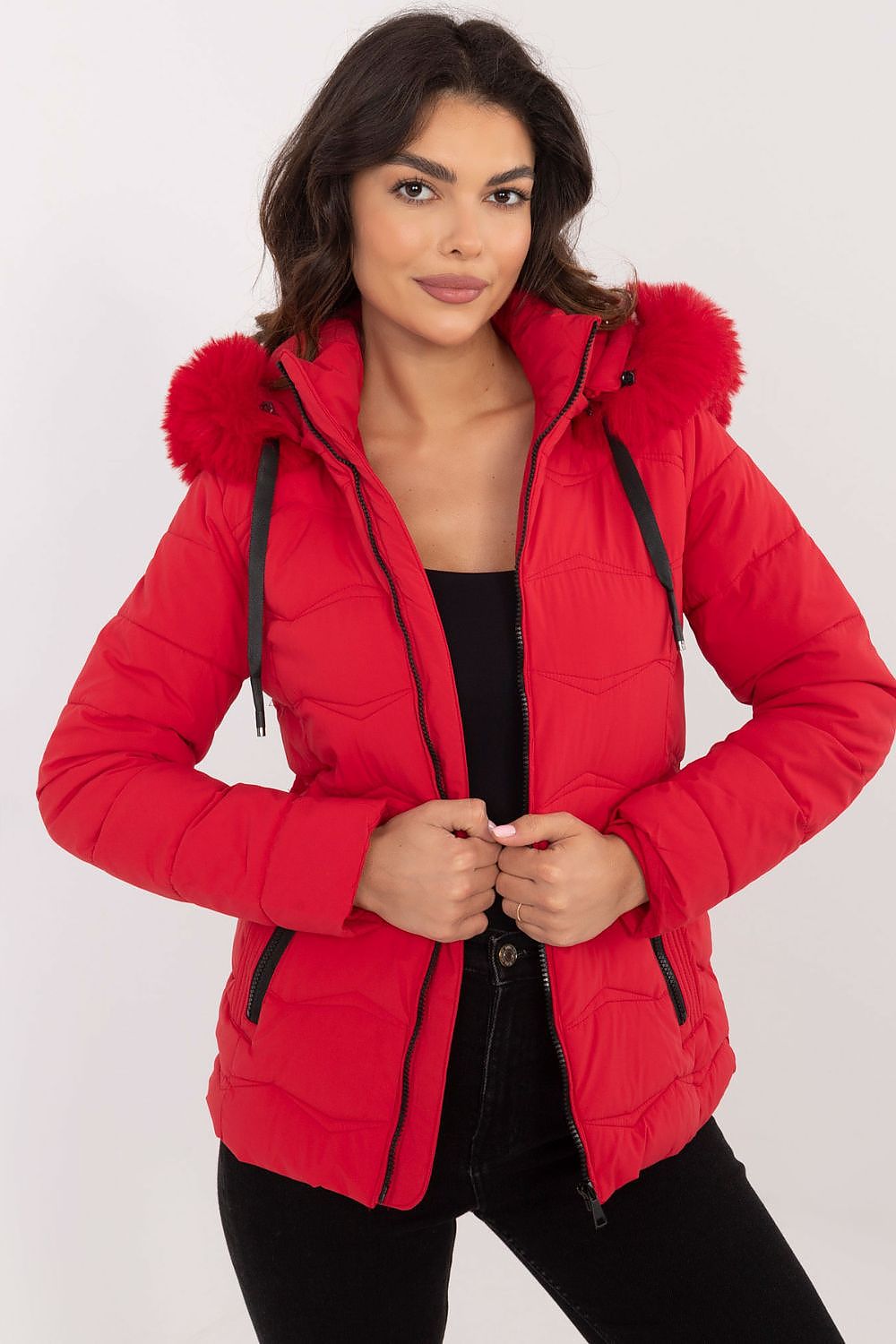 Woman wearing Veyra Short Quilted Jacket in red with detachable hood, showcasing sleek silhouette and contemporary quilted design.