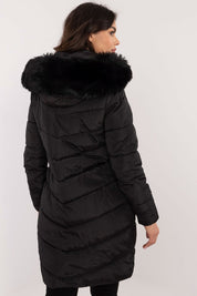 Woman wearing Aurlis Quilted Winter Jacket with faux fur trim, showing back view. Offers warmth and style for cold weather.