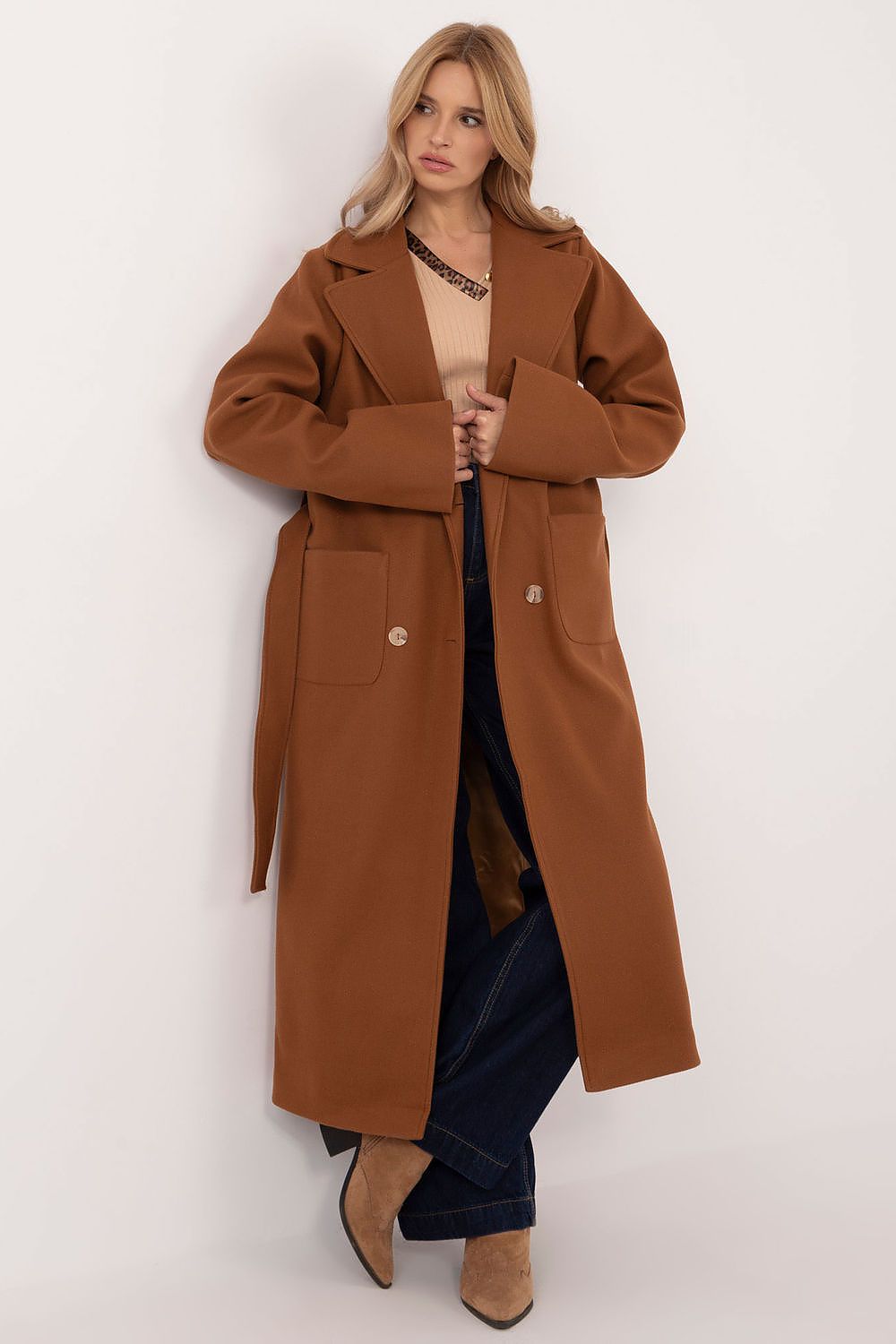 Woman wearing Olivanne Long Wool Blend Coat in brown, showcasing elegant design with wide lapels and waist tie, standing against white background.