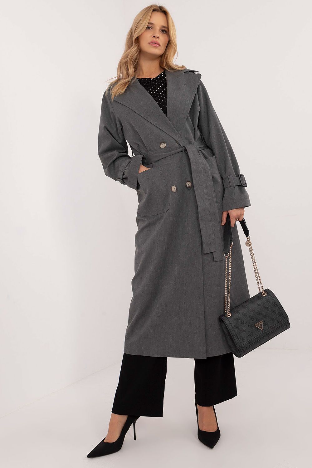 Woman wearing Elandra double-breasted trench coat, perfect for work and formal occasions, in a classic cotton blend with a calf-length cut.
