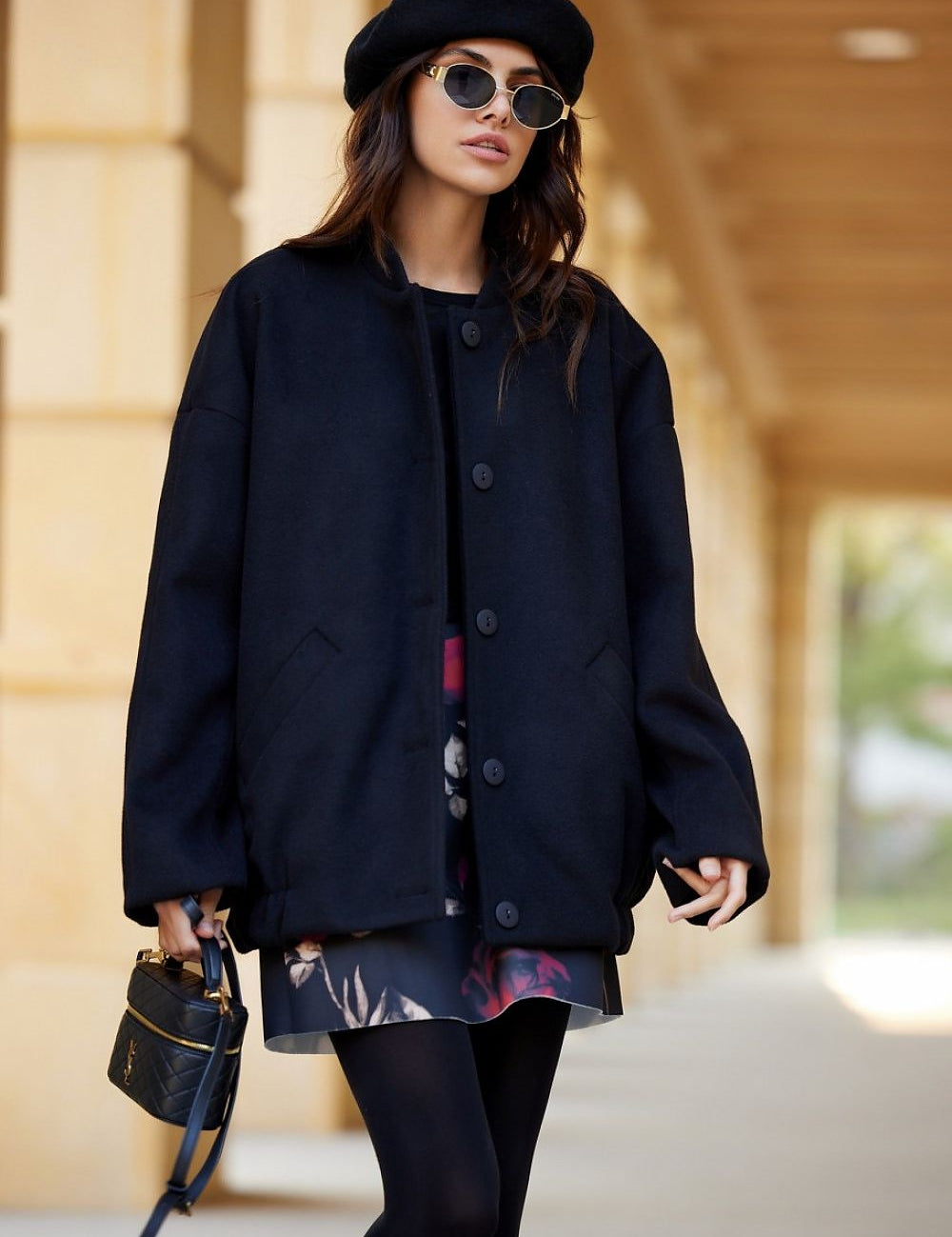 Woman wearing Vernelle Stand-Collar Buttoned Jacket, styled with a dress and beret, walking outdoors, showcasing casual elegance.