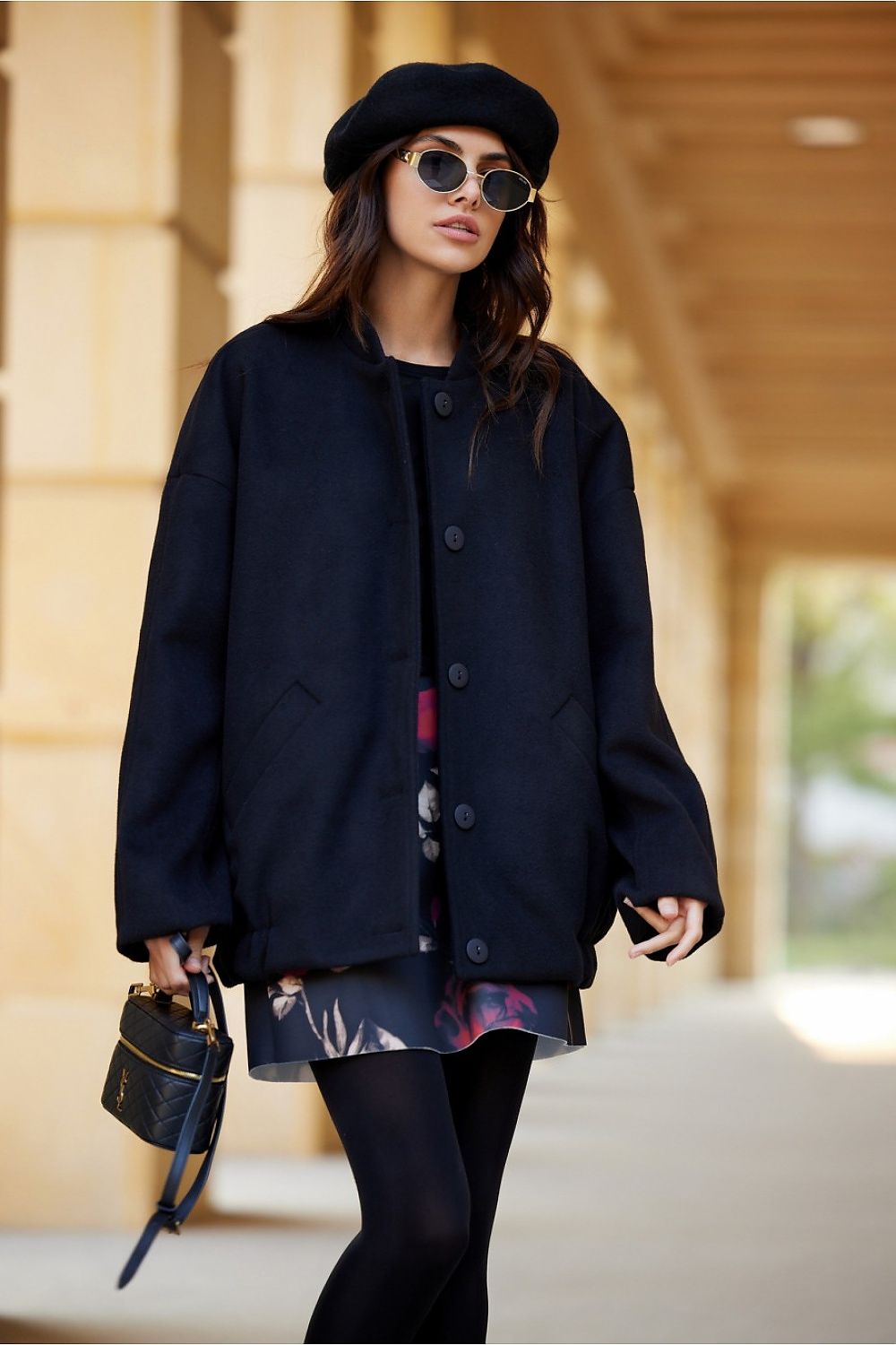 Woman wearing Vernelle Stand-Collar Buttoned Jacket, styled with a dress and beret, walking outdoors, showcasing casual elegance.