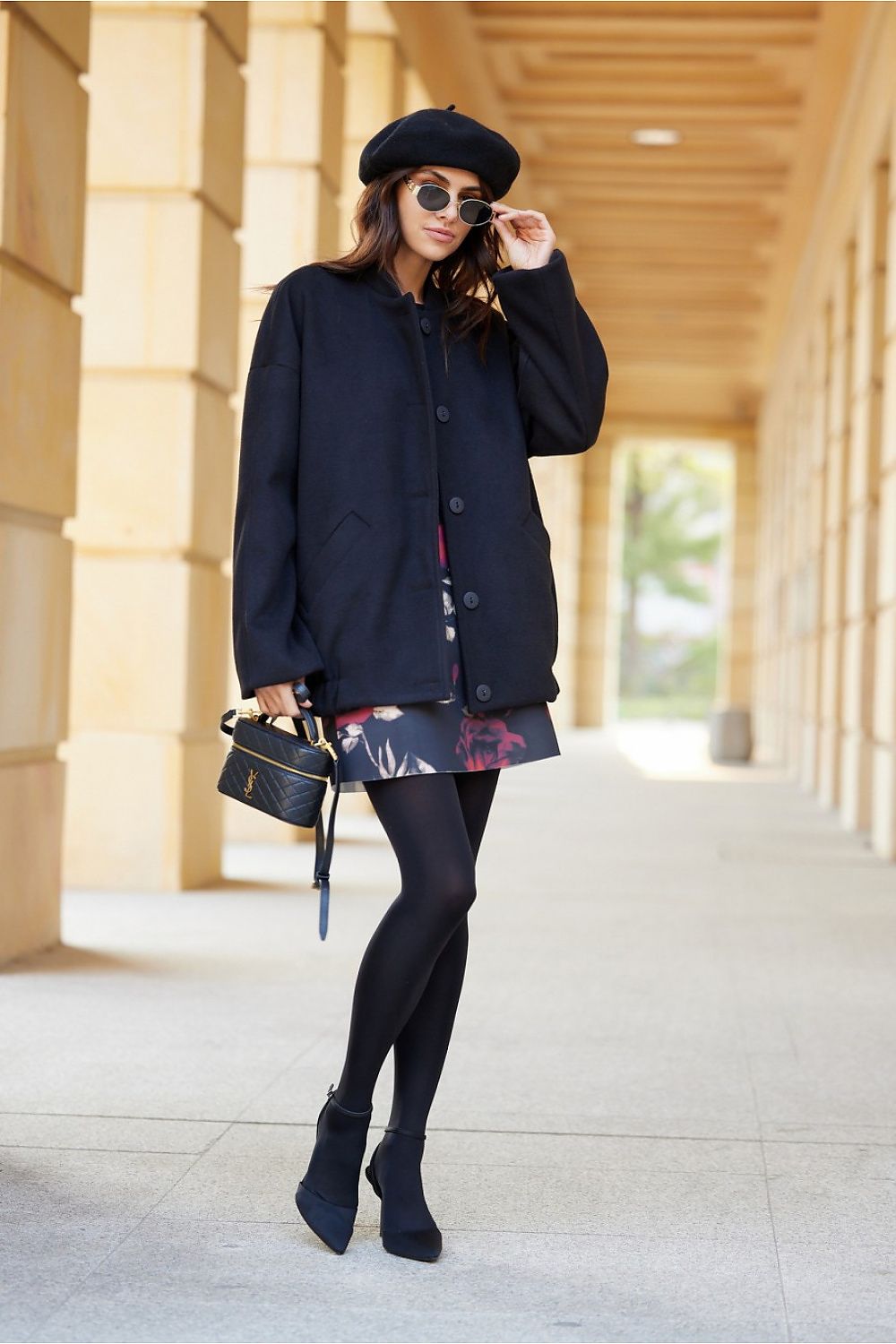 Woman in black Vernelle stand-collar buttoned jacket with beret and sunglasses, showcasing elegance and casual style in a relaxed fit.