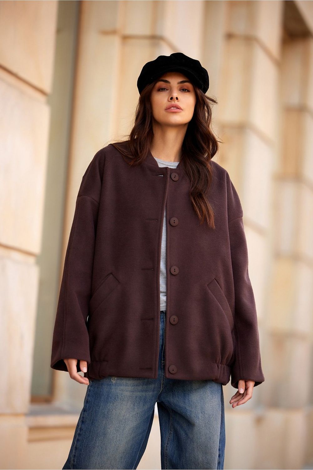 Woman wearing a Vernelle Stand-Collar Buttoned Jacket in dark fabric, paired with a stylish black beret, standing outdoors.