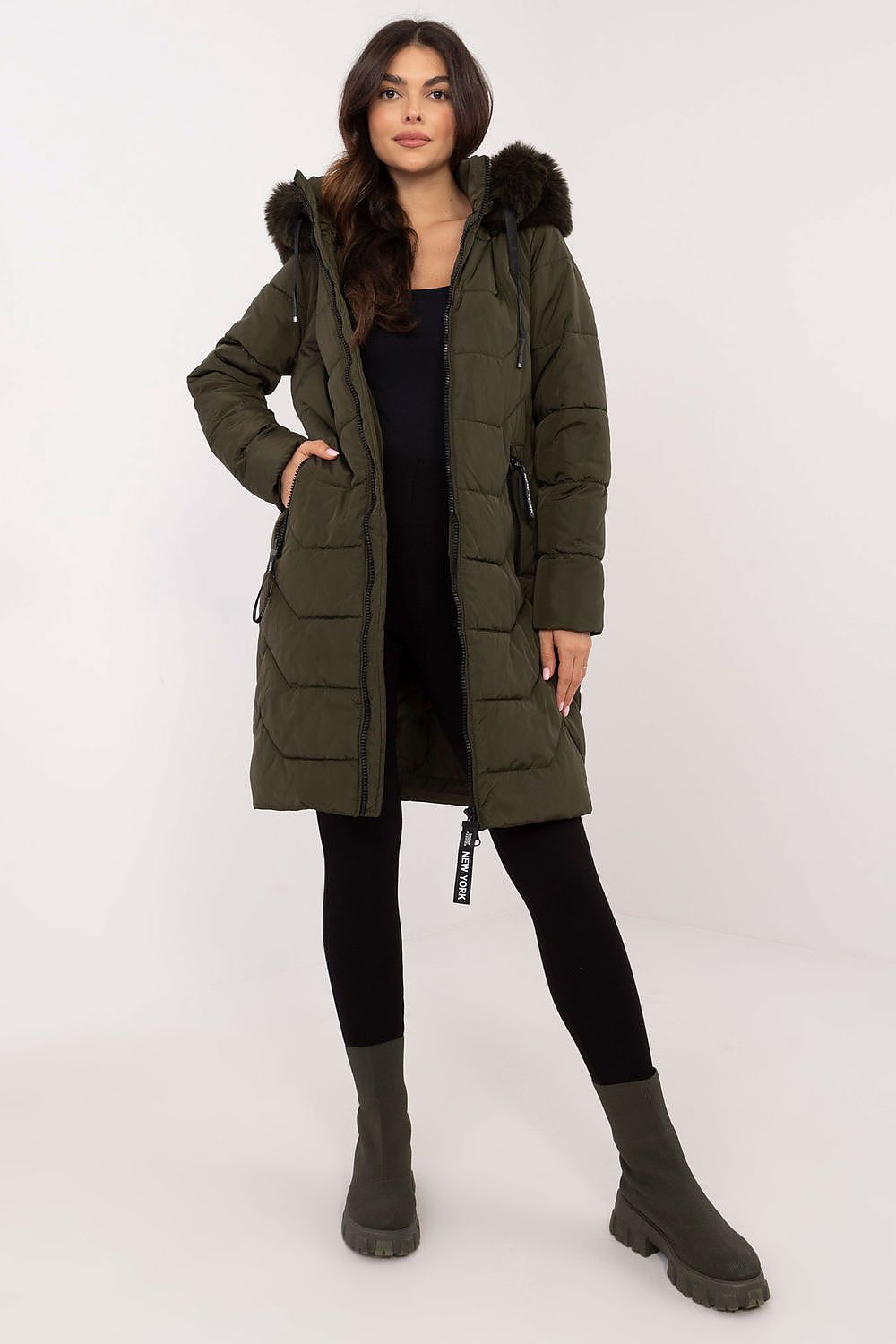 Woman wearing Elvarra Quilted Winter Down Coat with detachable hood and fur trim, perfect for autumn and winter style.