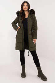 Woman wearing Elvarra Quilted Winter Down Coat with detachable hood and fur trim, perfect for autumn and winter style.