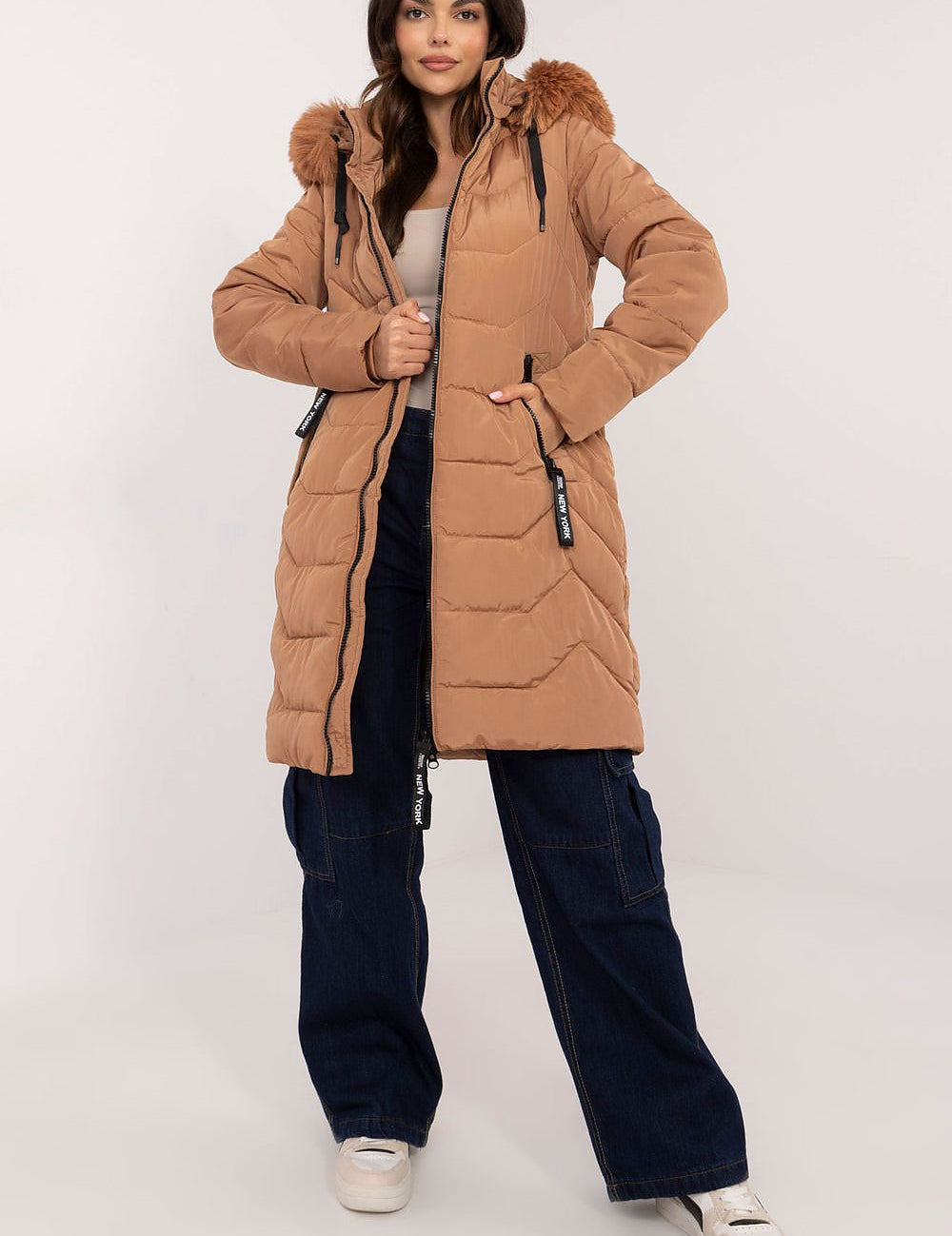 Woman wearing Elvarra Quilted Winter Down Coat with detachable fur-trim hood, ideal for stylish warmth in autumn and winter.