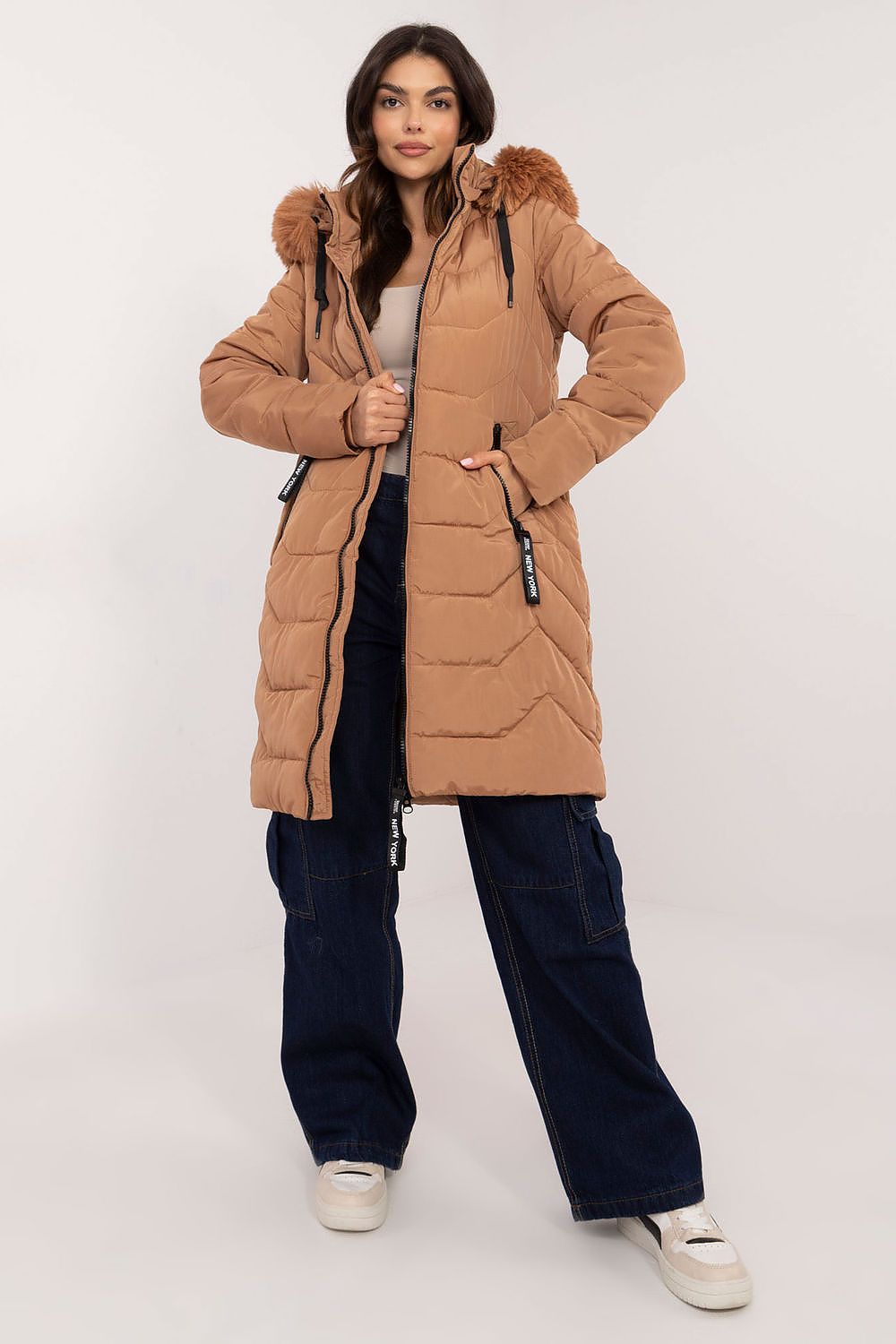 Woman wearing Elvarra Quilted Winter Down Coat with detachable fur-trim hood, ideal for stylish warmth in autumn and winter.