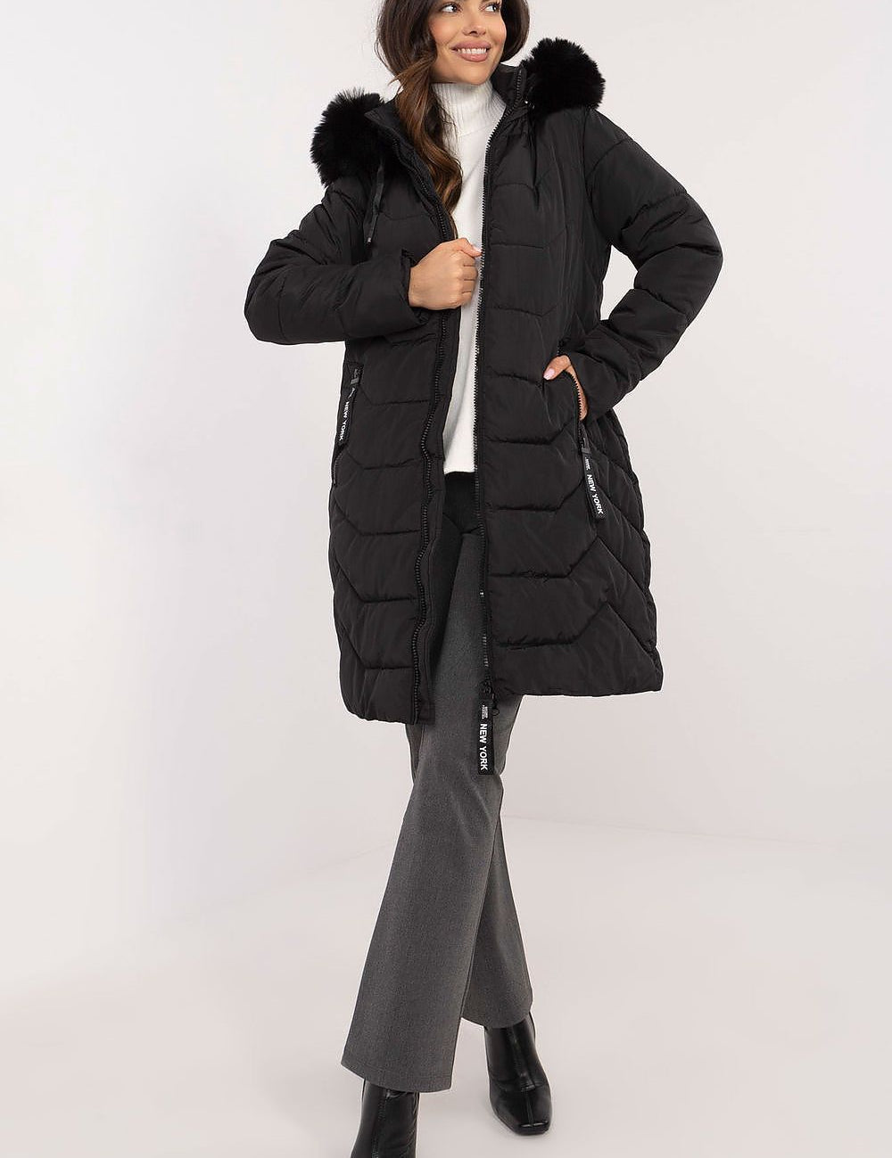 Woman wearing Elvarra Quilted Winter Down Coat with detachable hood and fur trim, perfect for autumn and winter warmth and style.
