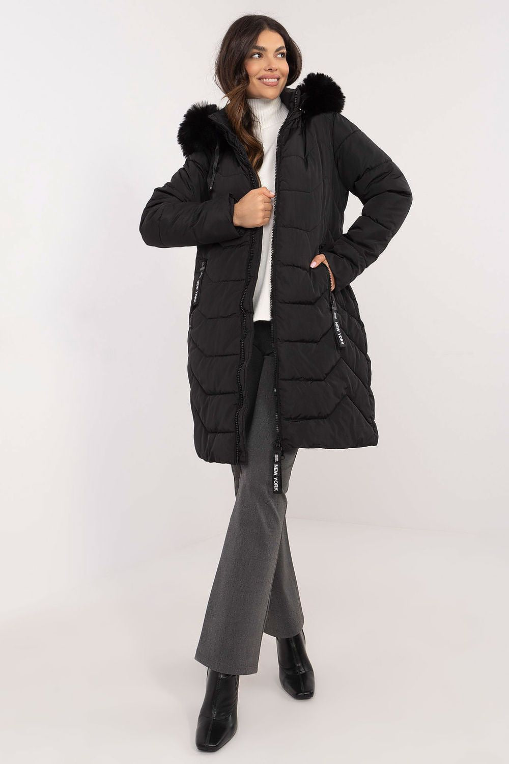 Woman wearing Elvarra Quilted Winter Down Coat with detachable hood and fur trim, perfect for autumn and winter warmth and style.