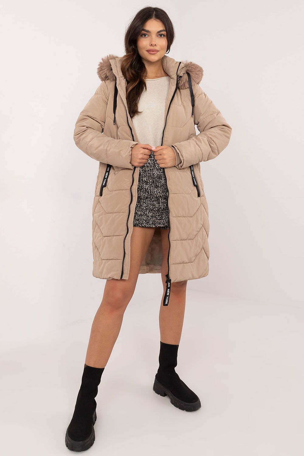 Woman wearing Elvarra Quilted Winter Down Coat with detachable fur hood, showcasing elegant and warm autumn-winter fashion.