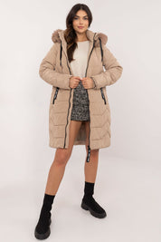 Woman wearing Elvarra Quilted Winter Down Coat with detachable fur hood, showcasing elegant and warm autumn-winter fashion.