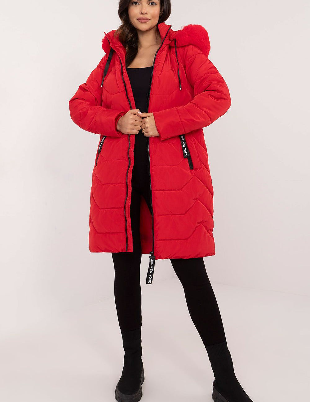 Woman wearing Elvarra Quilted Winter Down Coat in red with detachable fur-trim hood, showcasing urban style and warmth.