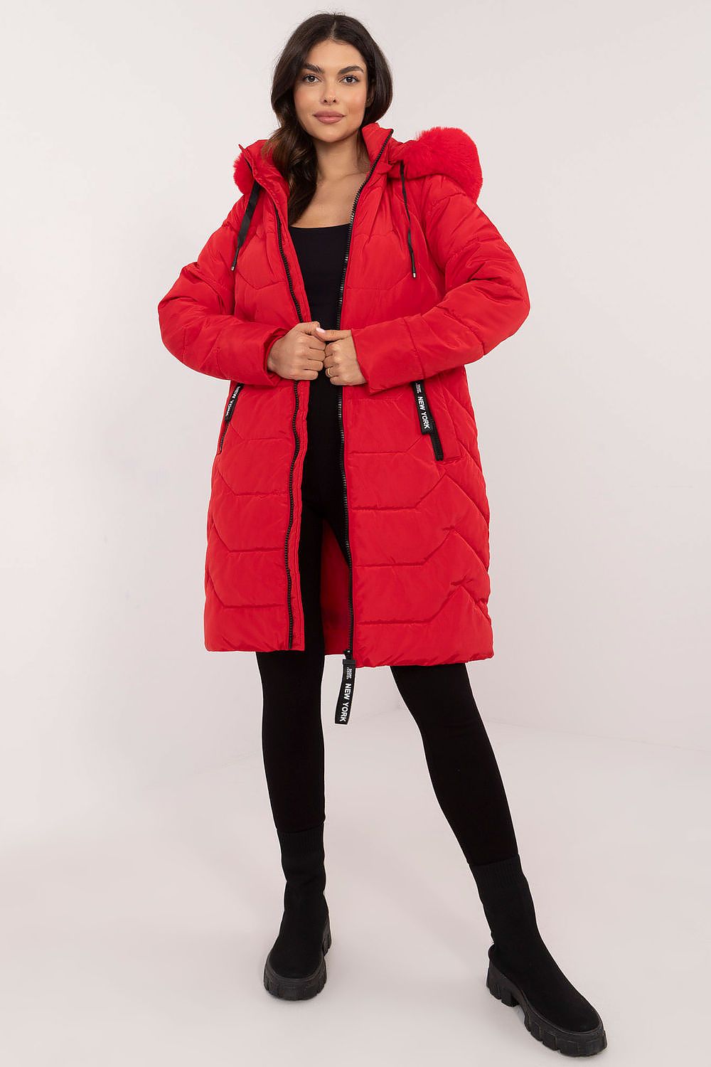 Woman wearing Elvarra Quilted Winter Down Coat in red with detachable fur-trim hood, showcasing urban style and warmth.