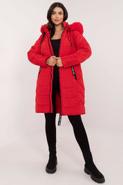 Woman wearing Elvarra Quilted Winter Down Coat in red with detachable fur-trim hood, showcasing urban style and warmth.