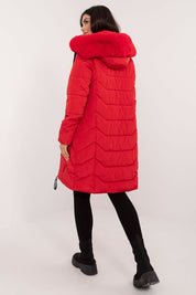 Woman wearing Elvarra Quilted Winter Down Coat in red with detachable hood, showcasing a knee-length design suitable for autumn and winter.