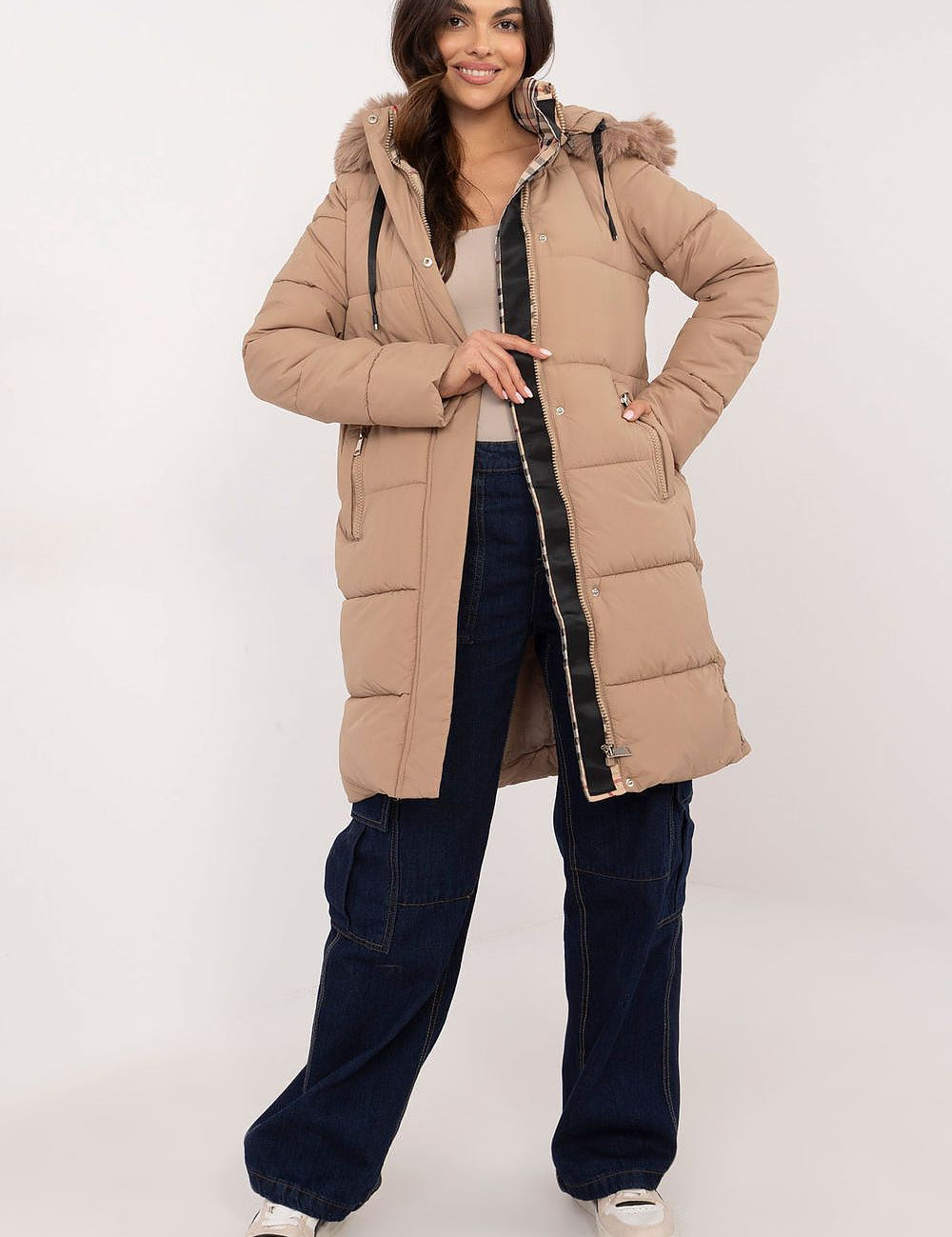 Woman wearing Arden Quilted Longline Winter Jacket with detachable hood, showcasing warmth and style for cold weather.