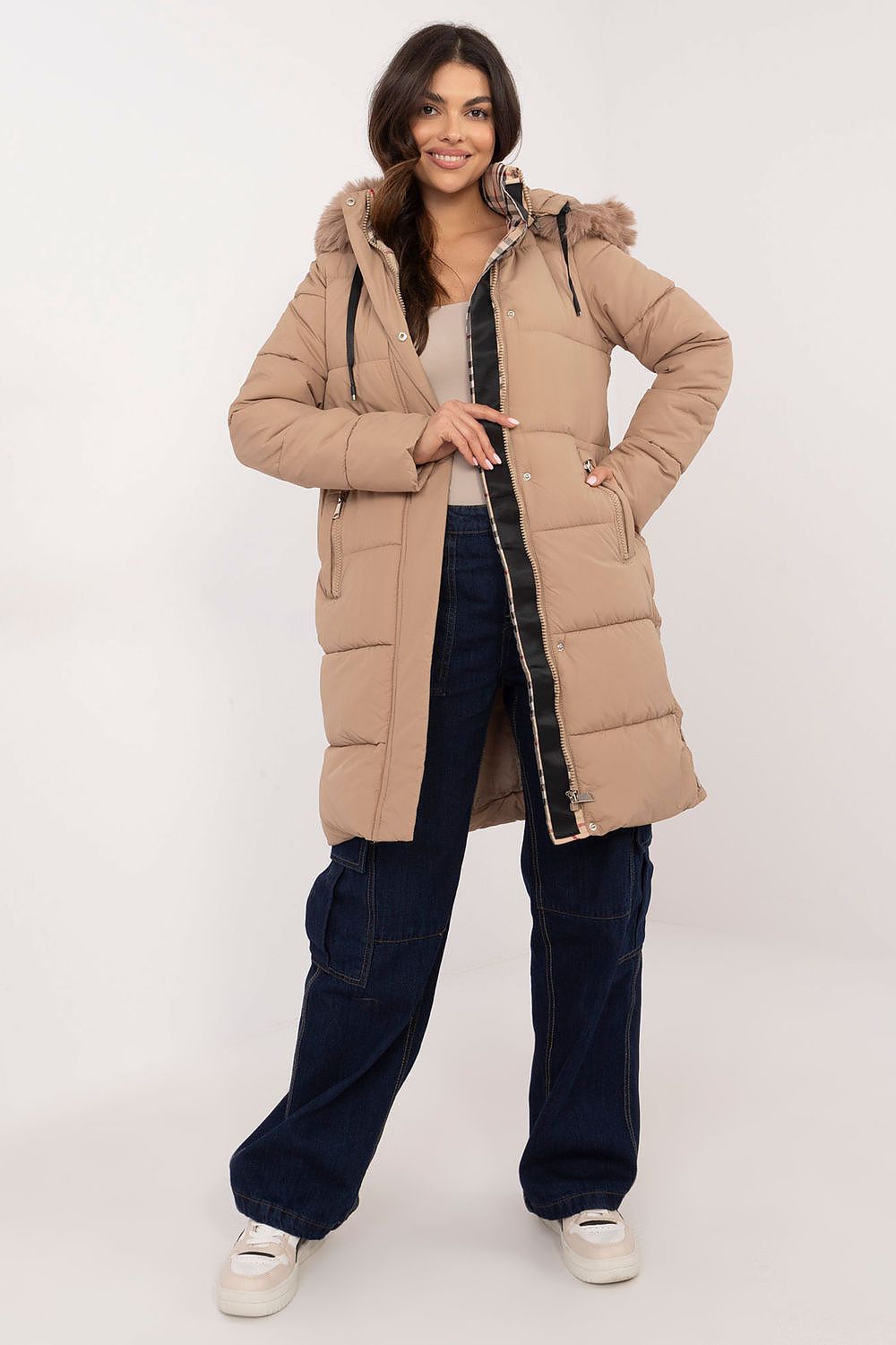 Woman wearing Arden Quilted Longline Winter Jacket with detachable hood, showcasing warmth and style for cold weather.