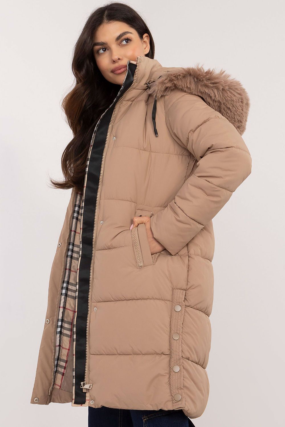 Woman wearing Arden Quilted Longline Winter Jacket with detachable hood and fur trim, showcasing warmth and style for winter.