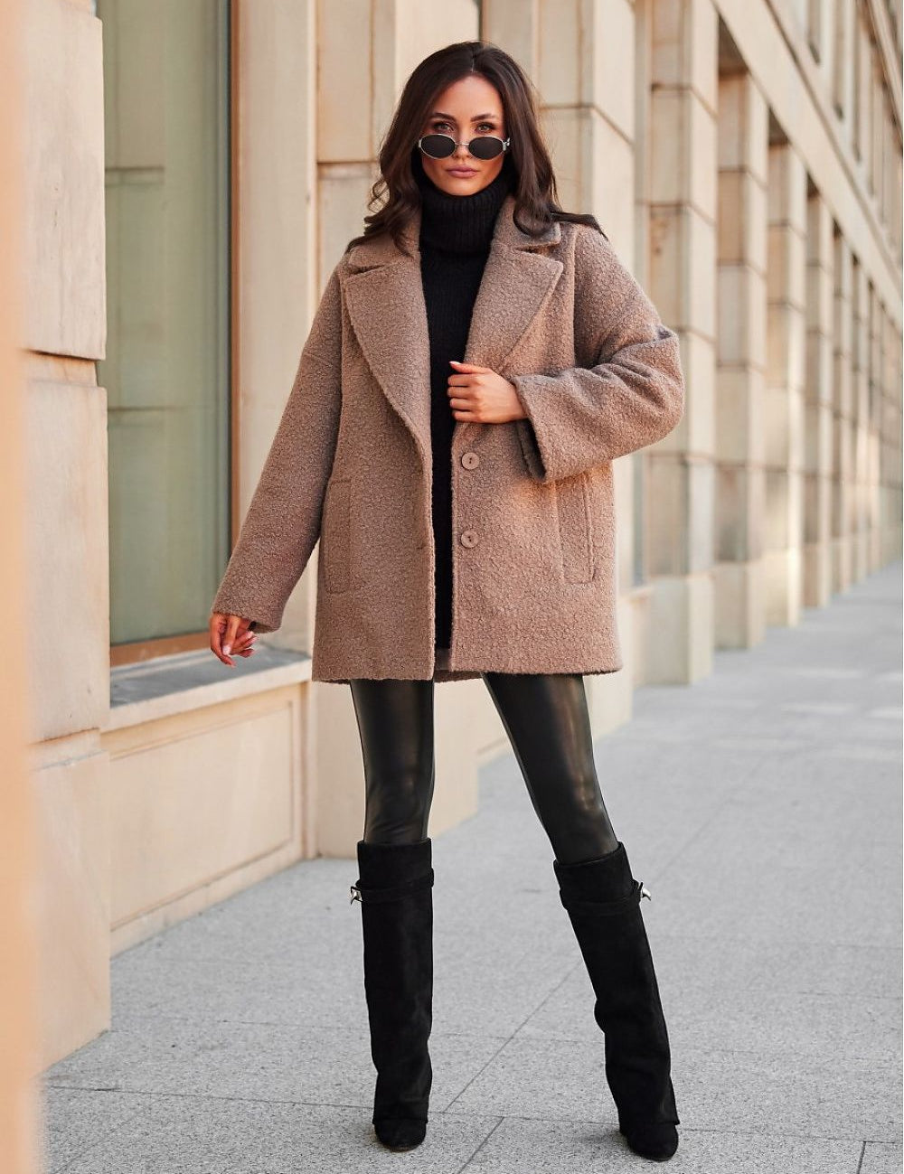Woman wearing stylish winter jacket with relaxed shoulders and structured collar, posing outdoors.