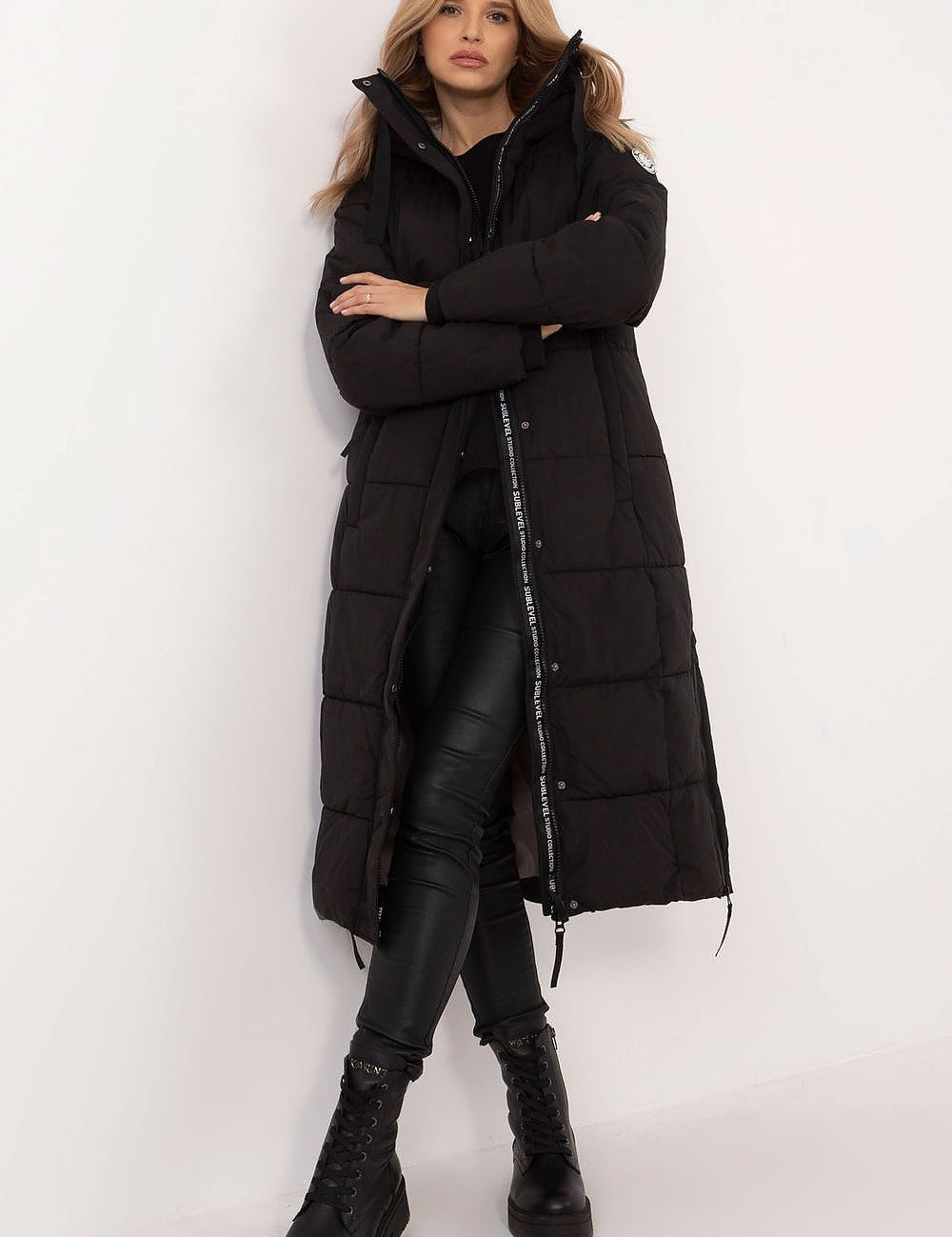Woman wearing Aurivelle Long Hooded Winter Coat, black, with windproof hood and warm synthetic filling, perfect for autumn and winter.