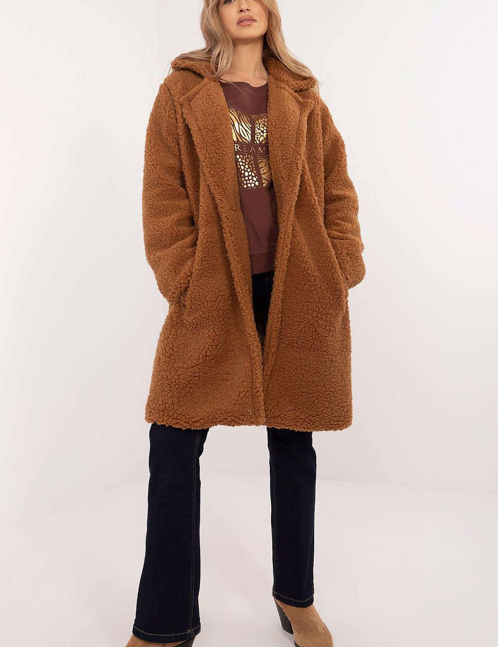 Woman wearing Elantra pre-knee winter coat in a cozy brown with a warm, elegant fit for versatile daily wear in cold seasons.