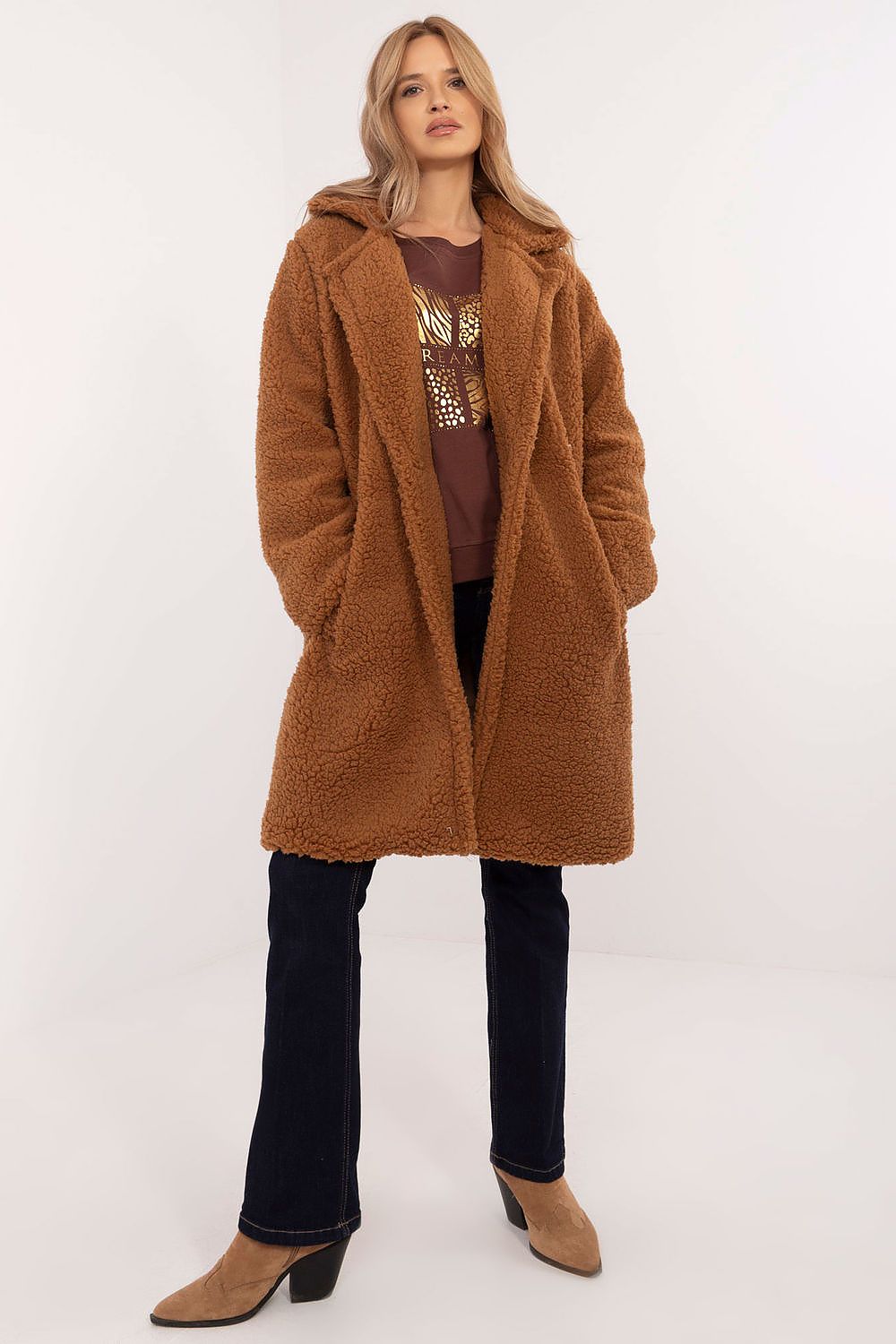 Woman wearing Elantra pre-knee winter coat in a cozy brown with a warm, elegant fit for versatile daily wear in cold seasons.