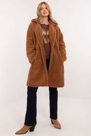 Woman wearing Elantra pre-knee winter coat in a cozy brown with a warm, elegant fit for versatile daily wear in cold seasons.