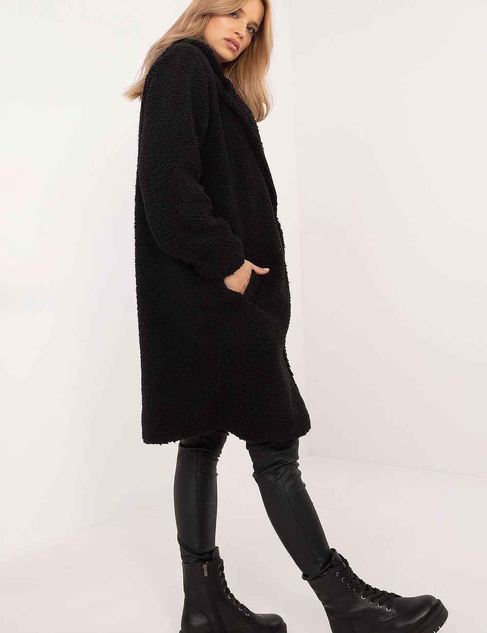 Woman wearing Elantra pre-knee winter coat in black, showcasing stylish and warm autumn-winter fashion with a classic silhouette.