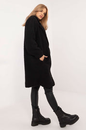 Woman wearing Elantra pre-knee winter coat in black, showcasing stylish and warm autumn-winter fashion with a classic silhouette.