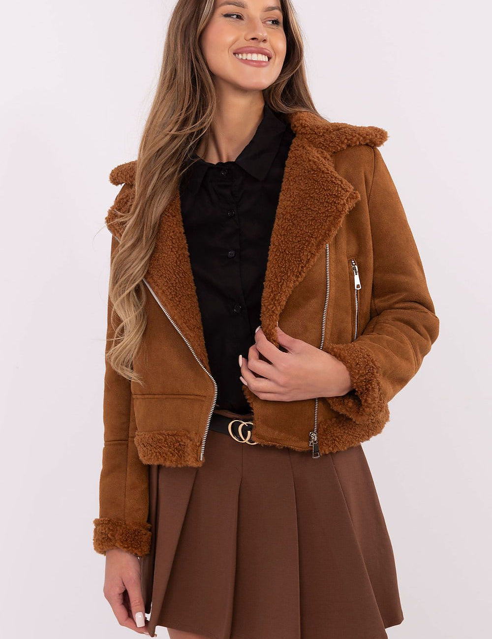 Woman wearing brown Arvelli insulated ramones jacket with zip closure and textured fabric, styled for autumn-winter fashion.