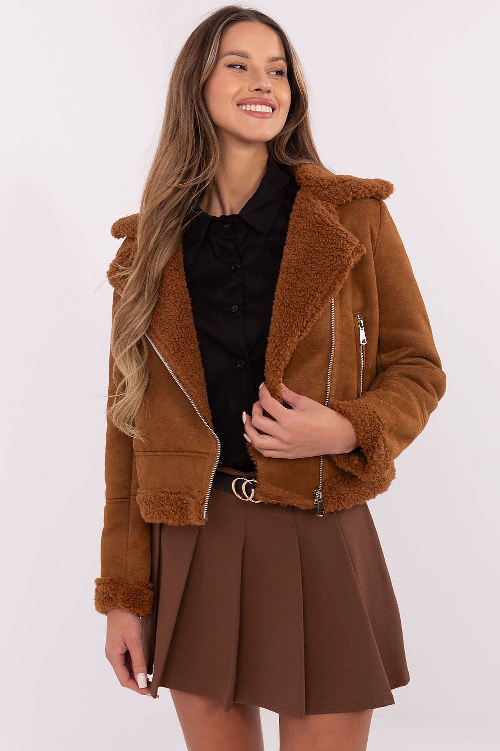 Woman wearing brown Arvelli insulated ramones jacket with zip closure and textured fabric, styled for autumn-winter fashion.