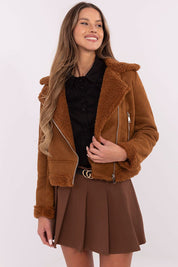 Woman wearing brown Arvelli insulated ramones jacket with zip closure and textured fabric, styled for autumn-winter fashion.
