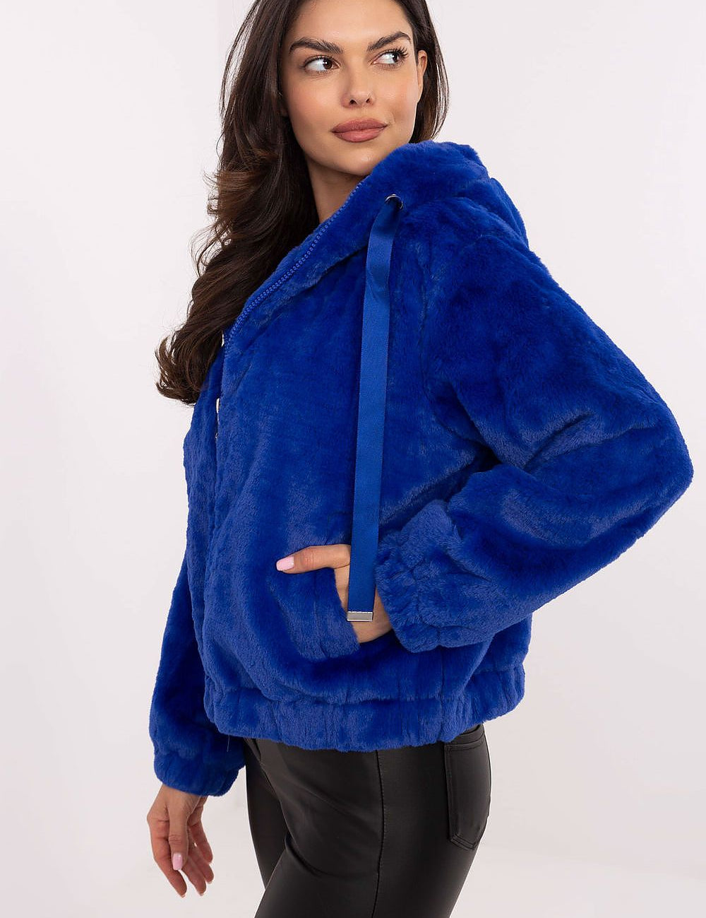 Woman wearing Corvalyn Hooded Teddy Bear Zip Jacket in vibrant blue, showcasing a casual fit with comfy hood and adjustable waist ties.