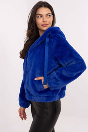 Woman wearing Corvalyn Hooded Teddy Bear Zip Jacket in vibrant blue, showcasing a casual fit with comfy hood and adjustable waist ties.