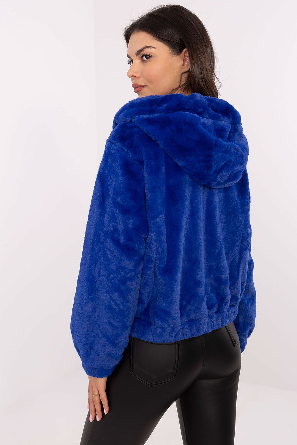 Woman wearing a blue Corvalyn Hooded Teddy Bear Zip Jacket with plush texture and hood, showcasing rear view in a casual setting.