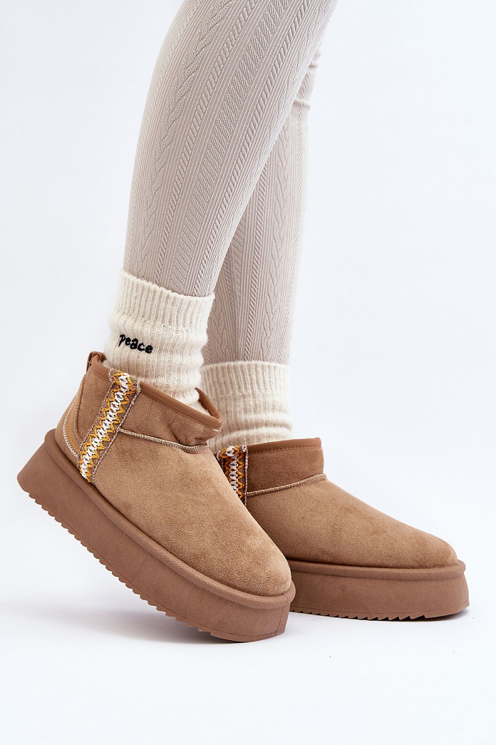 Azmira Aztec Platform Snow Boots on feet, featuring eco suede, plush fur lining, and Aztec pattern, perfect for winter citywear.