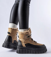 Norvaya Insulated Ankle Boots in brown with rugged sole, worn with leggings, ideal for winter; stylish and warm.