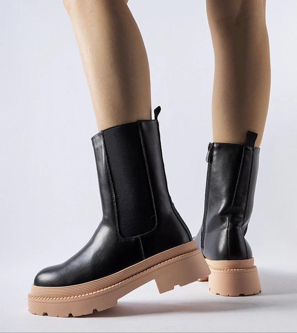 Zamari contrast-sole ankle boots with black eco leather and pink rubber sole, showing rounded toe and side zipper for easy wear.