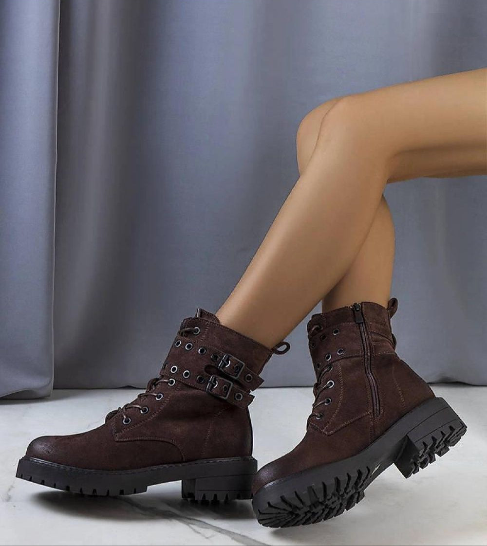 Woman wearing Ardevra insulated ankle boots with suede-look texture and bold strap detailing for autumn-winter fashion.