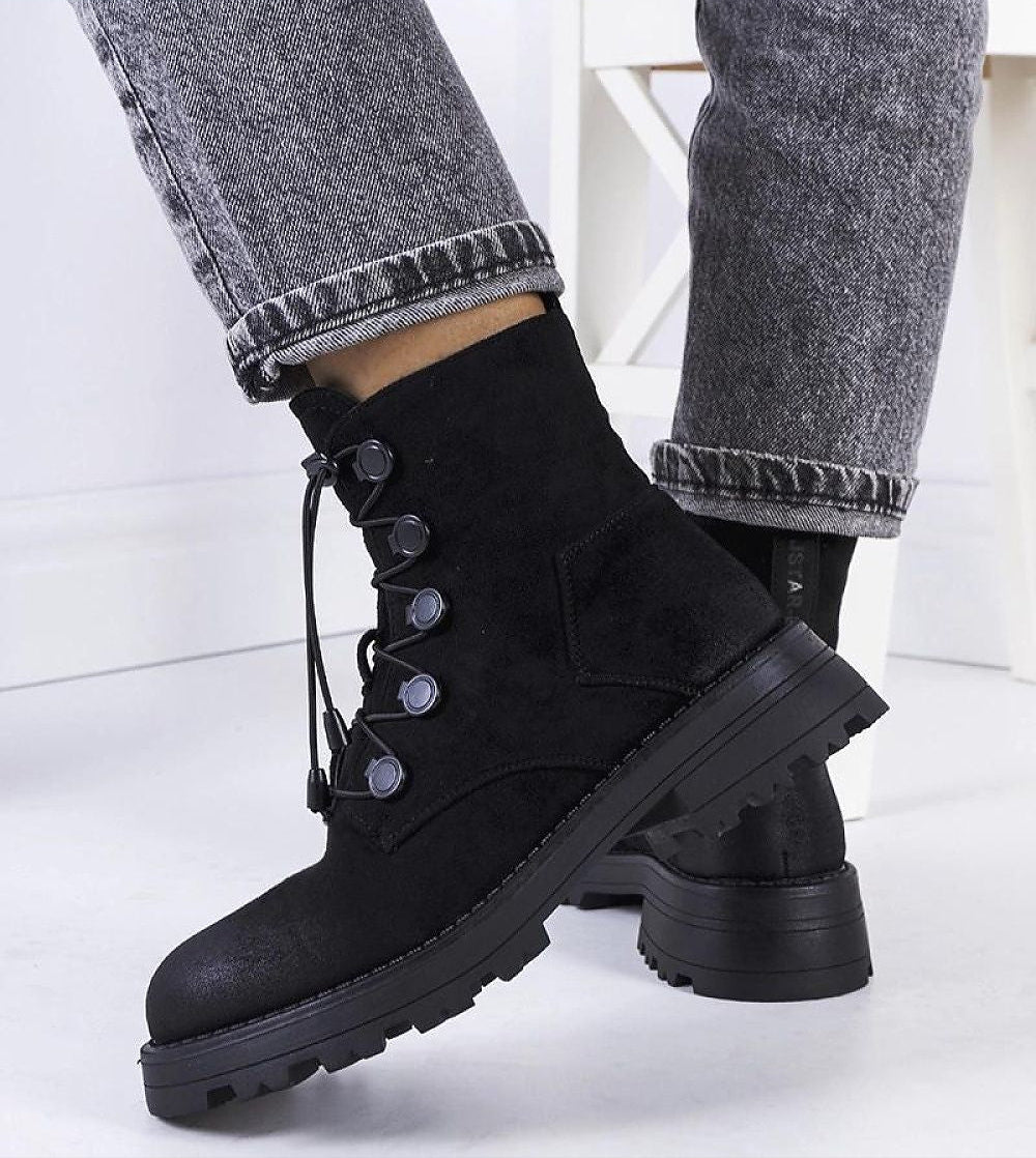 Virelda eco-suede ankle boots with lace-up front, ridged sole, and side zipper, shown in black with jeans for a stylish fall look.