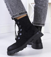 Virelda eco-suede ankle boots with lace-up front, ridged sole, and side zipper, shown in black with jeans for a stylish fall look.