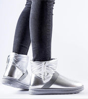 Brivona Glossy Velcro Snow Boots with insulated interior, shown on person wearing jeans, for winter elegance and waterproof protection.