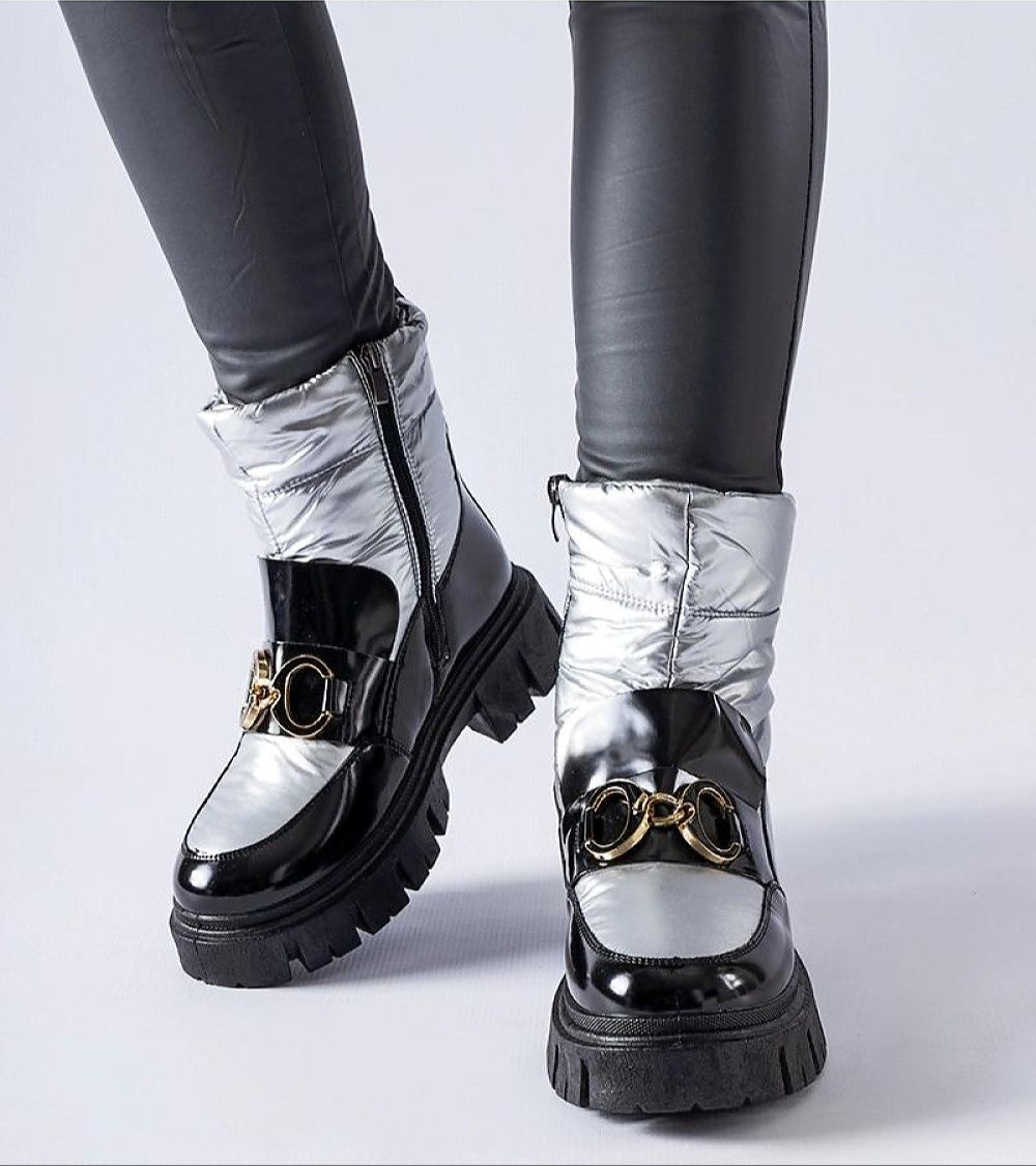 Nevelle insulated lacquered snow boots with black and silver tones, featuring a sturdy rubber sole and stylish design for winter wear.