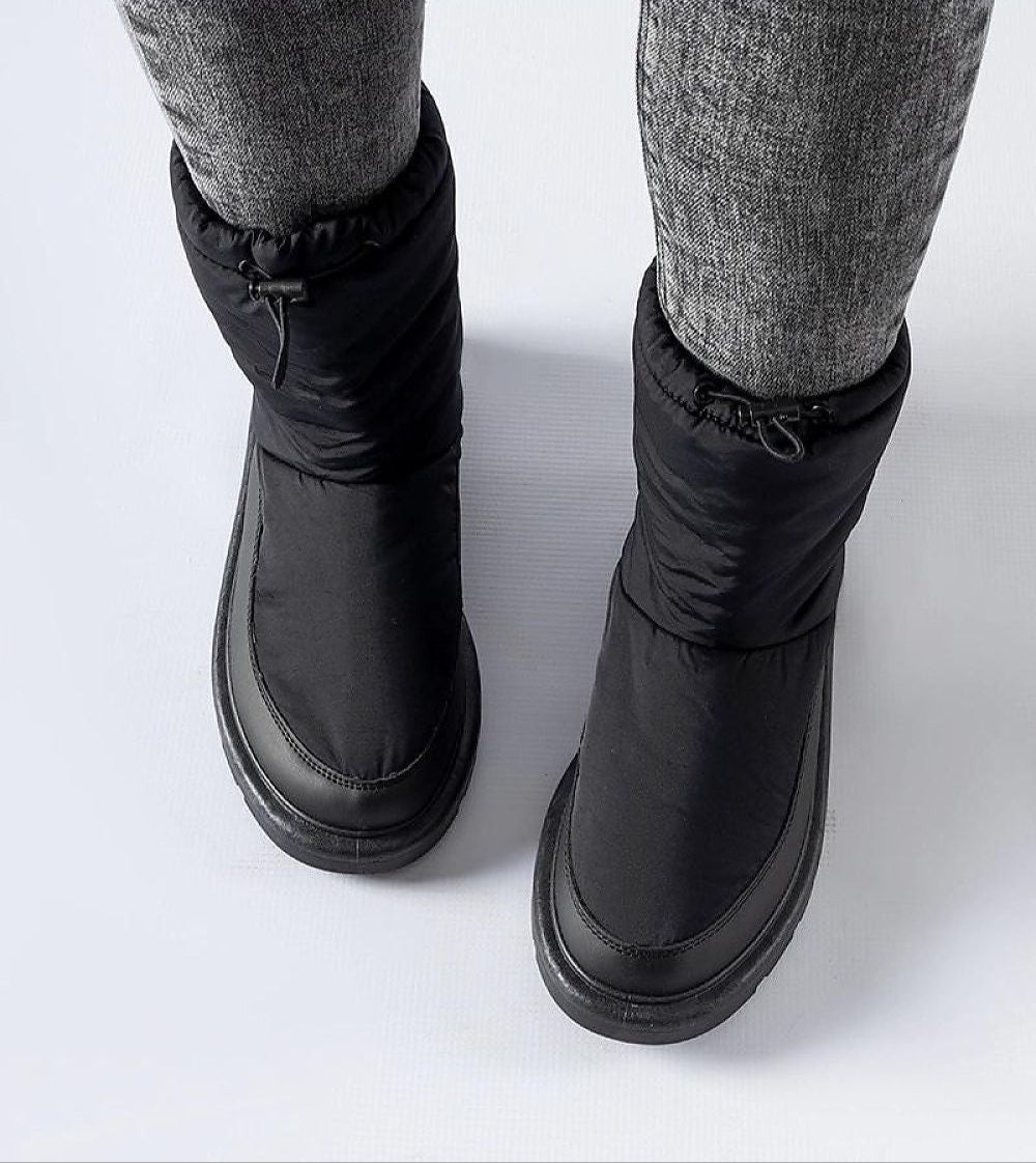 Black Sylverra Slip-On Winter Snow Boots with subtle platform and waterproof sole, designed for warmth and style in snowy conditions.