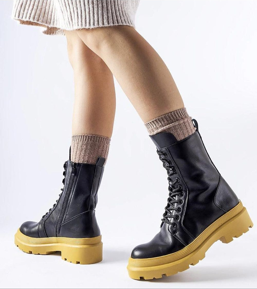 Black Vereliane Winter Boots with yellow soles and side zipper, offering style and warmth for cold-weather protection. High ankle design.