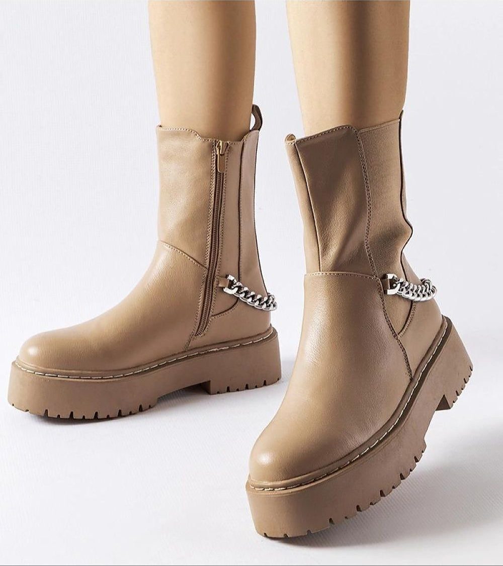 Guglielmo chain-trimmed flat ankle boots with beige sole and gold-tone chain embellishment, featuring side zipper closure.
