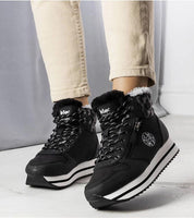 Person wearing Navarros Insulated Street Boots in black eco leather with white soles and faux fur lining, perfect for winter.
