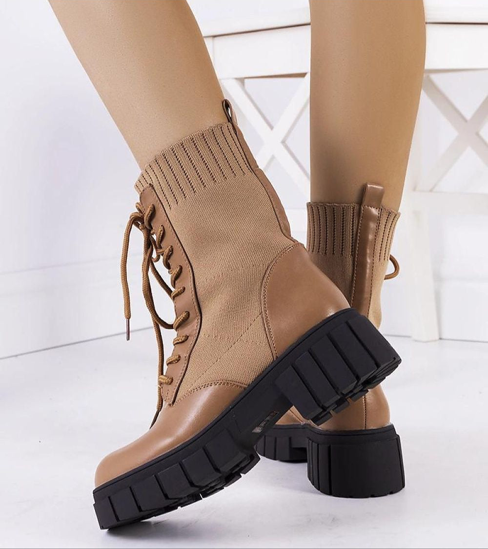 Braveda Brown Elastic-Top Boots with lace-up design and black treaded sole, showcasing eco leather and snug fit for autumn style.