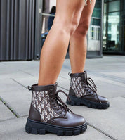 Woman wearing Ardenno Platform Lace-Up Boots in brown, showcasing rugged sole and stylish design for transitional wear.